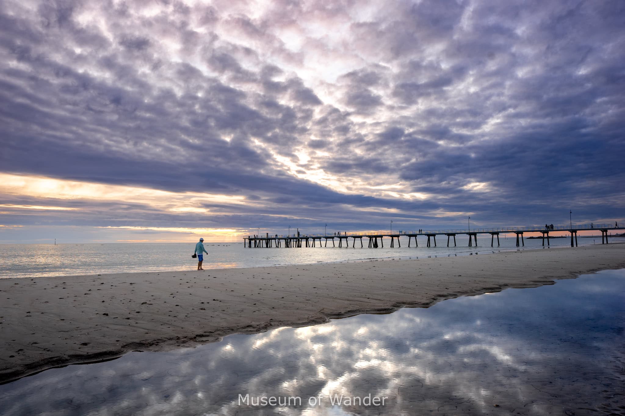 Glenelg Beach and jetty under a moody winter sky in July