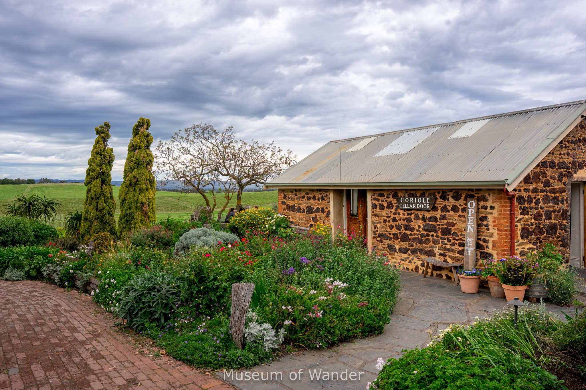 Coriole Cellar door in McLaren Vale. It's a small stone building surrounded by flowers and overlooking the vineyards